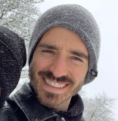 a man and woman are smiling in the snow