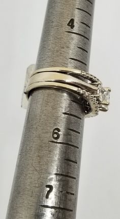 "We do not check prongs for wear or stones for looseness. All items are sold as is-noting that we are a resale shop so everything here had a previous owner! We will include flaws in the description when noted. This is one of the reasons our items are more affordable than new at a jewelry store. Vintage 14K White Gold Fused 3 Band Ring Set with 1 TCW Diamonds, Size 5.25. Stamped 14 KT and some lettering I can't make out. The Diamond(s) have been soft graded I1;I2 by the jewelry shop we use for re Stackable Emerald-cut Diamond Anniversary Ring, Stackable Emerald Cut Diamond Anniversary Ring, Formal Stackable Emerald Cut Diamond Ring, Stackable Emerald Cut White Gold Rings, Three Stone Diamond Ring In 14k Silver Gold, Formal Fine Jewelry Stackable Three-stone Rings, 14k Gold Three Stone Diamond Ring, 14k Gold Diamond Ring With Three Stones, White Gold Stackable Emerald Cut Wedding Ring