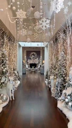 a hallway decorated for christmas with white and silver decorations