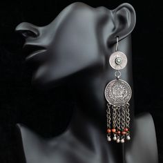 Long dangly earrings made in Bukhara, Uzbekistan in the 1990s. The main elements are silver Bavarian coins dated 1785, and the smaller silver coins are Indian rupees, presumably acquired via trade routes. The coins have been made into these unusual earrings with the addition of coral dangles and a small turquoise bead. The ear hooks are 0.8 mm in width suitable for wearing. Please note, they are a little heavier as they are made from coins. Different and unique. Suitable for wearing or collecting. Please note, earrings cannot be returned for hygiene reasons. Date: 1990s Material: Silver, coral & turquoise Dimensions: Drop 11.2 cm Wire width: 0.7 mm Weight: 28.4 g Ref: EAR-720 --- CUSTOMS AND IMPORT TAXES: Buyers are responsible for any customs and import taxes that may apply. I'm not respo Silver Coin Jewelry, Indian Rupees, Bukhara Uzbekistan, Coin Jewellery, Adornment Jewelry, Unusual Earrings, Jewellery Vintage, Jewellery Indian, Coin Earrings