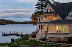 a large house sitting next to a body of water