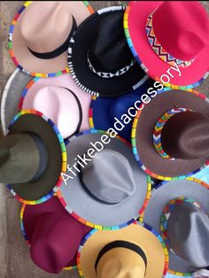 Beautifully beaded Set of 5 fedora hats. They contain the beadwork both at the brim and at the edge. Available in different colours and all you need is to tell us your preferred colours.  Wholesale for more than 5 fedoras also available  Free shipping Is also an added advantage and its via DHL EXPRESS Beaded Hat Brim, Beaded Hats, Fedora Hat Style, Fedora Fashion, Jingle Dress, Beaded Hat Bands, African Hats, Hats Summer, Hat Bands