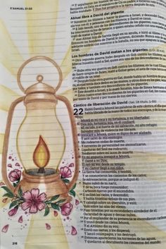 an open book with flowers and a lantern on it's page, in spanish