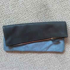 a black and blue purse sitting on top of a carpet