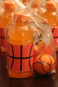 orange juice bottles wrapped in plastic with basketballs