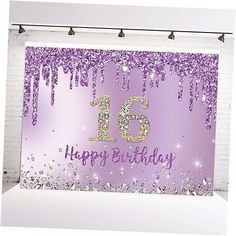 a birthday card with the number sixteen on it and purple glitters hanging from strings