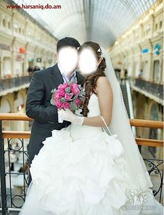 a bride and groom are posing for a photo in the train station with their bouquets