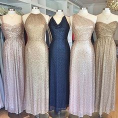 four dresses on mannequins in different colors and sizes, all lined up