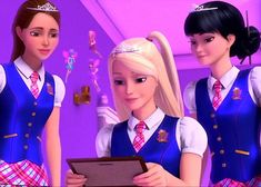 three girls in school uniforms are looking at a tablet