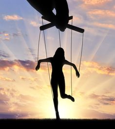 the silhouette of a person swinging on two strings in front of an orange and blue sky