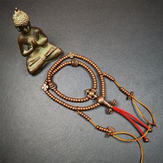 ❤This mala was collect from Hepo Town Baiyu County Tibet, blessed in Yaqing Monastry.It is made of copper,brown color,length is 44cm / 18",has 1 Kartika ,2 skeletons, 2 stamp pendant, and 2 strings of counters with phurba + kartika.❤DETIALS100% HandmadeMaterial:red copperSize:Mala'perimeter is 44cm,18 inches.108 bodhi beads: 5mm ,about 0.2"1 kartika:2.7cm ,about 1.1"2 skull beads:1.1cm * 1.1cm ,about 0.43" * 0.43"2 counters: 6cm long, about 2.36"❤ Great Mala For Meditation and Yoga Practitioners 2 Skeletons, Lotus Sutra, Tibetan Mala, Skull Beads, Copper Brown, Green Tara, Red Copper, The Monks, Beaded Skull