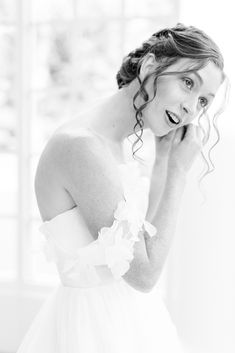 bride leans forward and adjust earrings in atrium of the Belk Chapel | Charlotte wedding day at Belk Chapel and the Palmer Building with North Carolina wedding photographer Kevyn Dixon Photography.