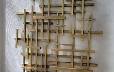 a sculpture made out of wooden planks on a wall