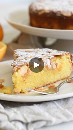 a piece of cake sitting on top of a white plate next to an orange slice