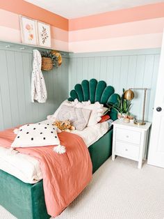 a bedroom with pink, green and white walls