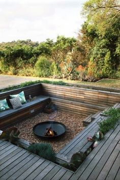 a fire pit in the middle of a wooden deck