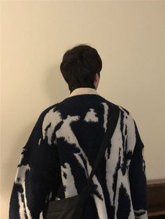 the back of a person wearing a black and white sweater