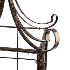 an iron bed frame with curved designs on it