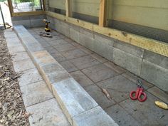 two pairs of scissors sitting on the ground in front of a building