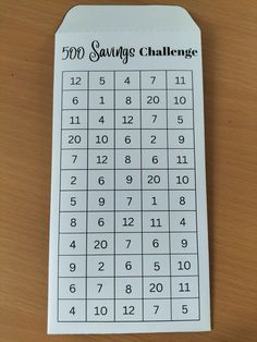 a printable 50 savings challenge game on a wooden table with the numbers in black and white