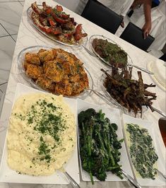 a table topped with plates filled with different types of food next to mashed potatoes and asparagus