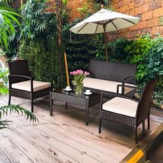 two chairs and a table on a deck with an umbrella