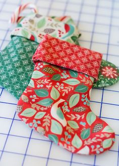 four pieces of fabric sitting on top of a cutting board