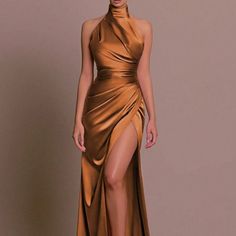 a woman in a gold dress with high slits on the side and one leg