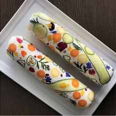 two slices of cucumber on a plate with flowers and leaves painted on them