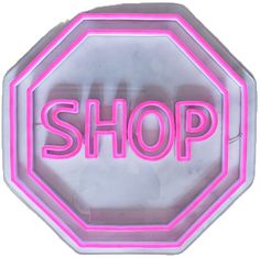 a neon sign with the word shop written on it in pink and white letters that spell out