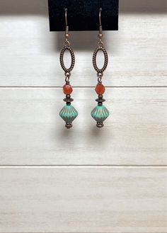 "Long boho dangle earrings created using Czech glass bicone beads in matte turquoise with etched copper accents, burnt orange Czech fire polish glass beads, small copper beads, and spacer beads.  These are wire-wrapped to antique copper oval connectors.  Total length of earrings, including the ear wire, is approximately 2-1/2\". Matching necklace: https://www.etsy.com/listing/1519124092/beaded-bohemian-necklace-with-copper?click_key=5b35150b8614b4eac85f62531910e6638ba2c2a0%3A1519124092&click_sum Bohemian Czech Glass Crystal Earrings Nickel Free, Bohemian Czech Glass Earrings With Ear Wire, Bohemian Nickel Free Czech Glass Earrings, Bohemian Crystal Earrings With Adjustable Czech Glass, Bohemian Czech Glass Crystal Earrings Adjustable, Bohemian Nickel-free Czech Glass Earrings, Bohemian Crystal Earrings With Adjustable Fit, Bohemian Czech Glass Dangle Earrings, Bohemian Czech Glass Drop Earrings