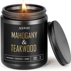 a candle that is sitting next to a container with the words mahogany and teakwood on it