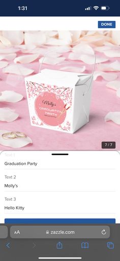 an open box with the word congratulations party on it and some pink petals around it