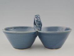 two blue bowls sitting next to each other