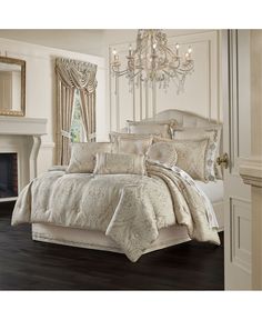 a large bed in a room with a chandelier