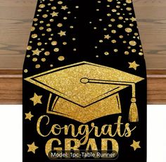 congratulations grad table runner with gold stars on black and gold graduation cap in the center