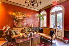 a living room filled with furniture and a chandelier