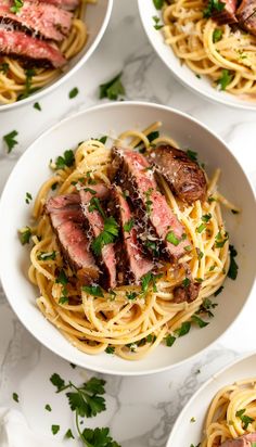 four white bowls filled with pasta and meat on top of a marble countertop next to chopsticks