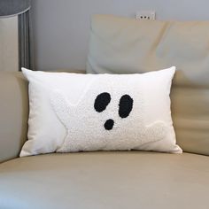 a white pillow with black eyes on it