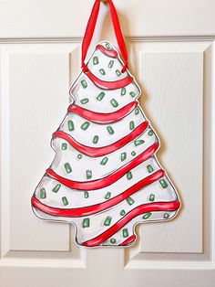 a glass christmas tree ornament hanging on a door