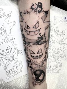 a person with a tattoo on their arm that has an evil face and two faces