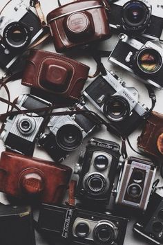 many old cameras sitting on top of each other