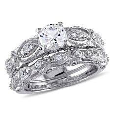 a wedding ring set with an oval cut diamond in the center and two rows of round diamonds on each band