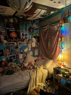 a messy bedroom with many pictures on the wall