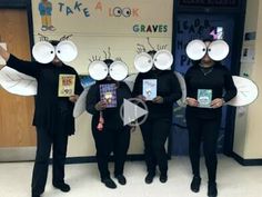 a group of people with paper plates on their heads holding up books and reading masks