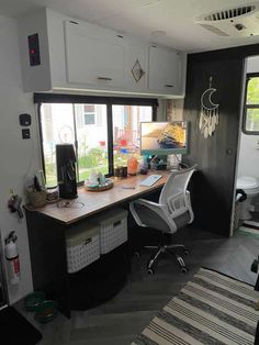 a home office area with desk, chair and large sliding glass door that opens to the backyard