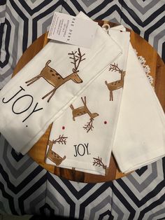 three white napkins with reindeer on them