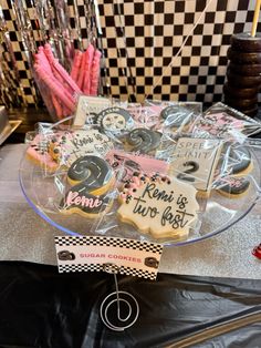 some cookies that are on a glass platter and sitting on top of a table