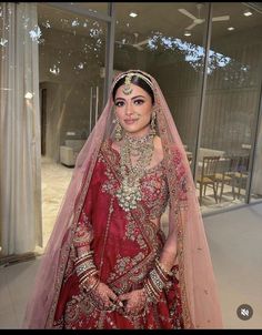 a woman in a red and gold bridal gown