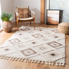 a living room with a chair and rug on the floor